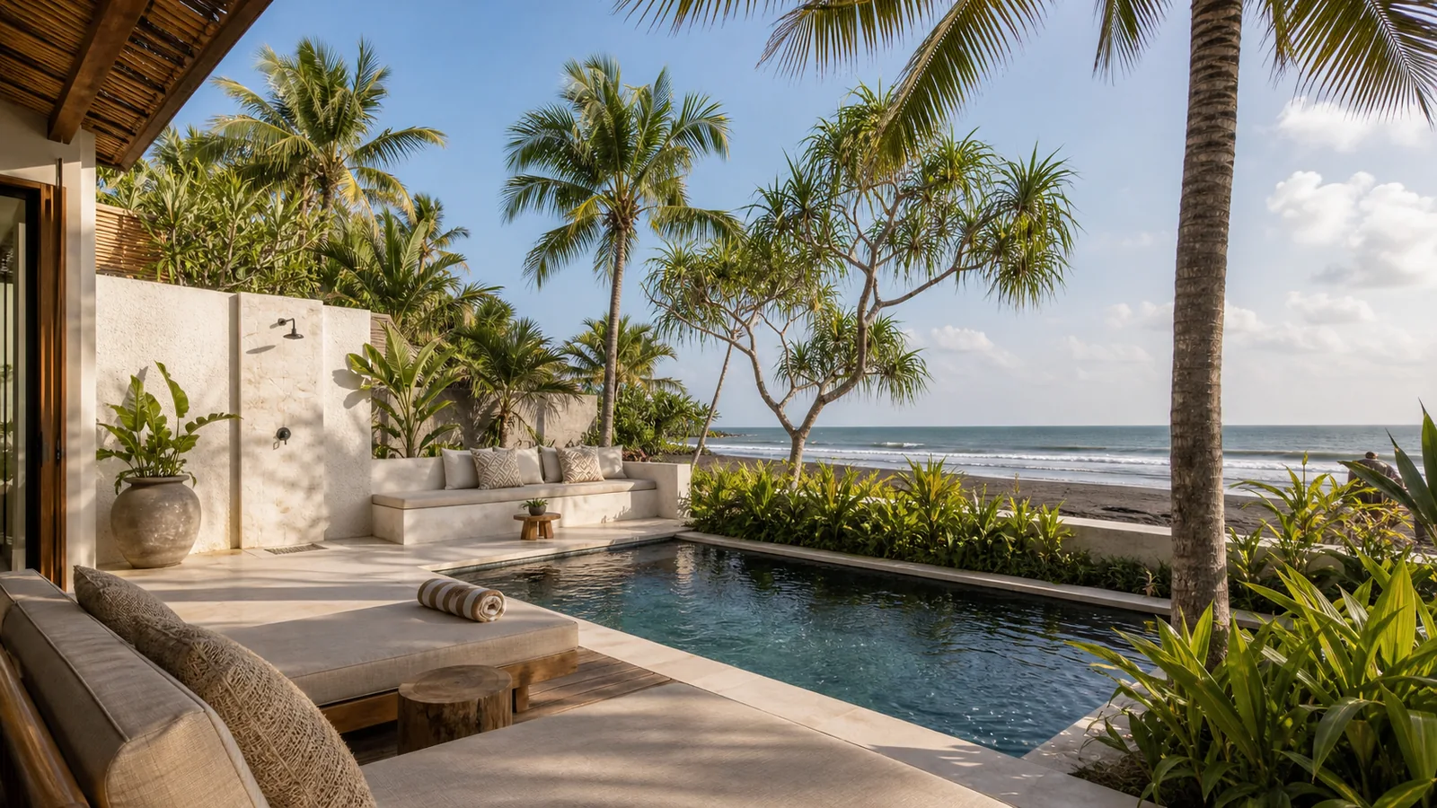 Seseh beachfront villa pool deck beside volcanic sand beach